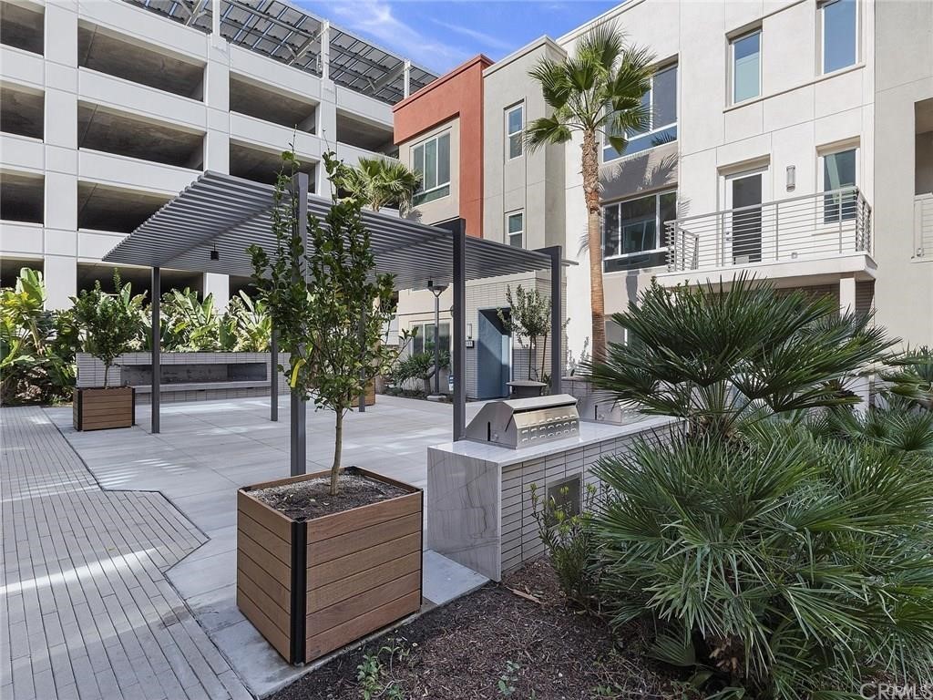 106 Citysquare Irvine, CA 92614 - Photo 21 of 21 a view of a patio with table and chairs and potted plants