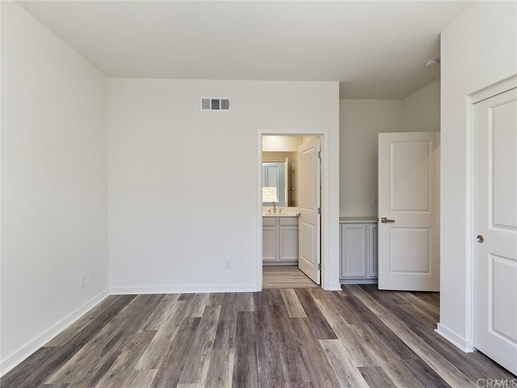 106 Citysquare Irvine, CA 92614 - Photo 4 of 21 a view of a room with wooden floor and bathroom