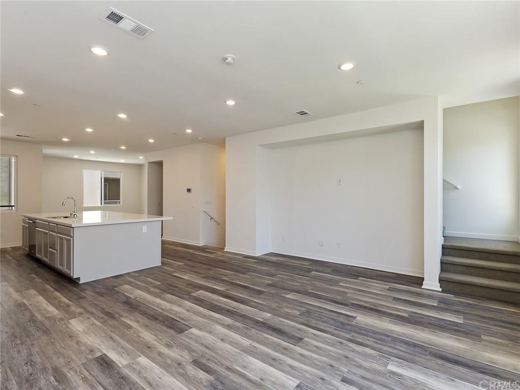 106 Citysquare Irvine, CA 92614 - Photo 7 of 21 a view of kitchen and wooden floor