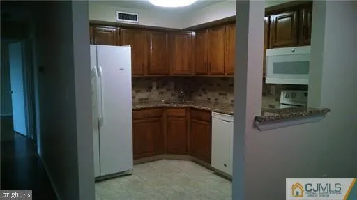 a kitchen with a refrigerator and cabinets