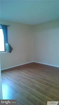 a view of wooden floor and windows in a room