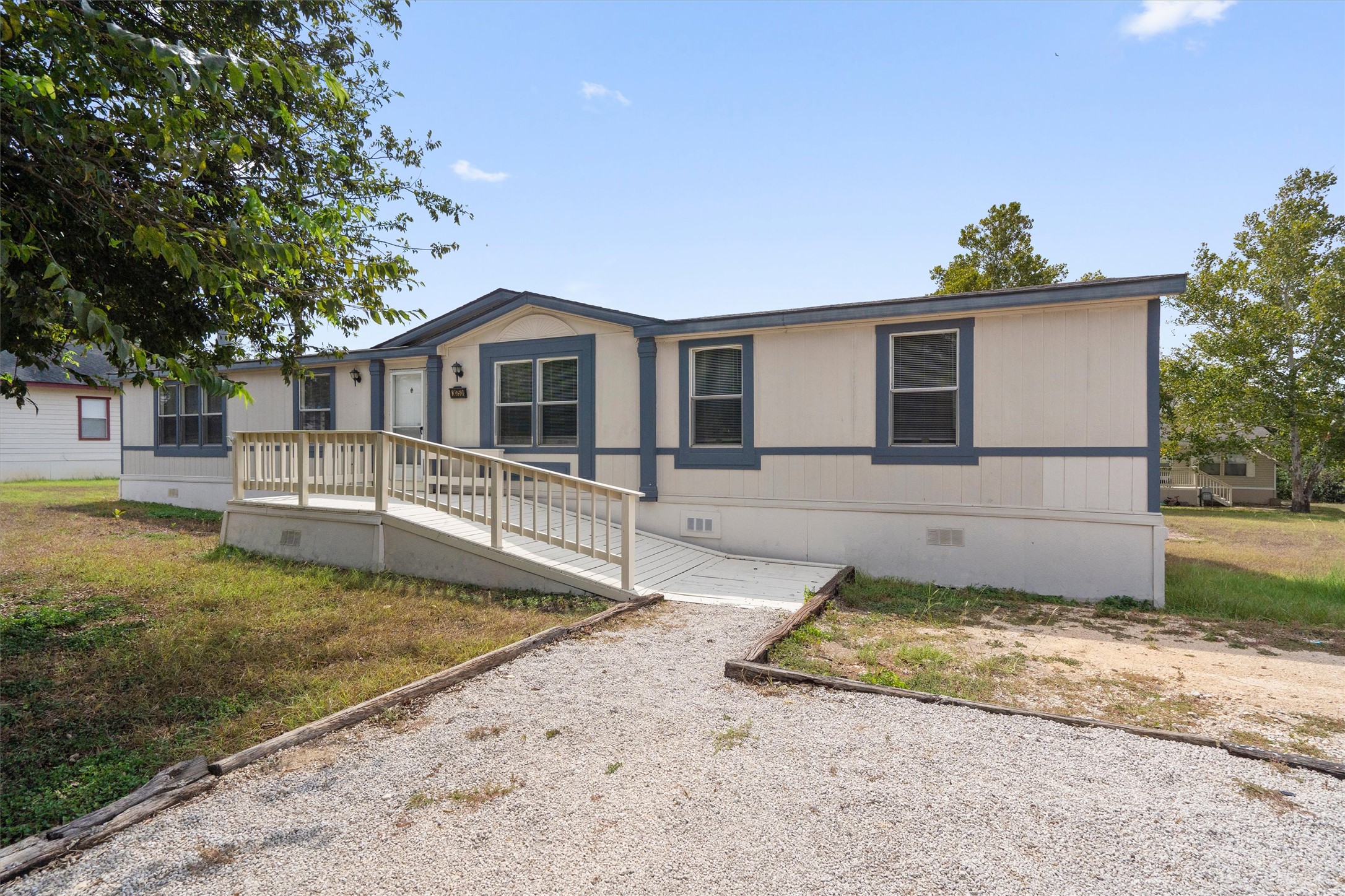 3075 Old Black Colony Road, Unit D Buda, TX 78610 - Photo 1 of 26 A gravel pathway leads directly to the front ramp and deck of this classic home.