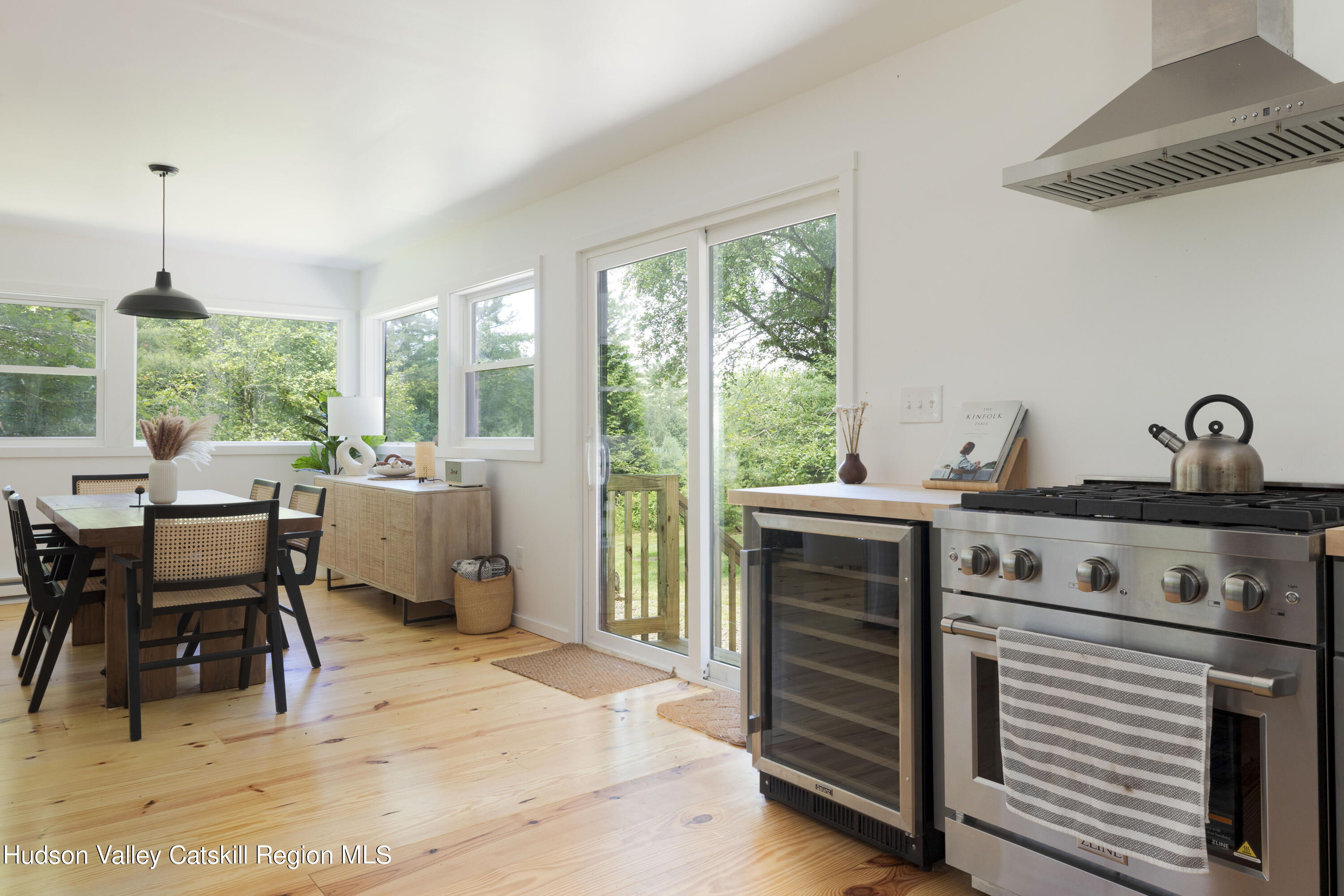 5646 Red Hill Road Claryville, NY 12725 - Photo 17 of 30 a kitchen with a stove a refrigerator and a dining table