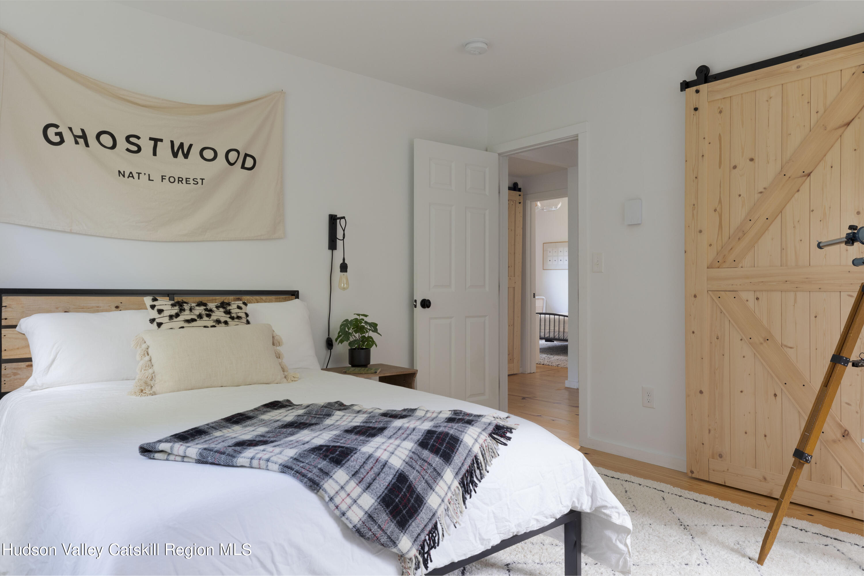 5646 Red Hill Road Claryville, NY 12725 - Photo 20 of 30 a bedroom with a bed and a mirror