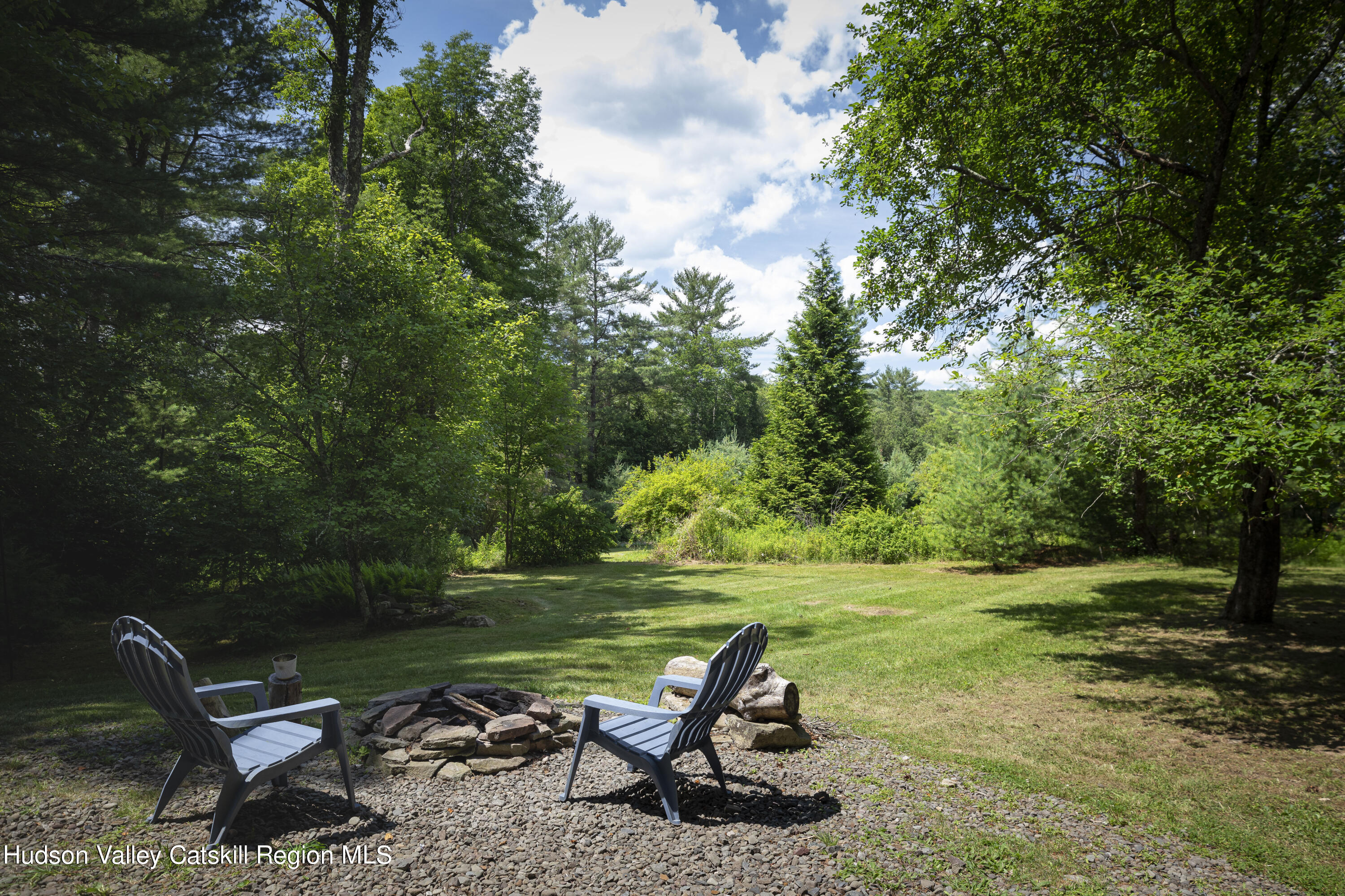 5646 Red Hill Road Claryville, NY 12725 - Photo 2 of 30 a view of a lake with a yard and sitting area