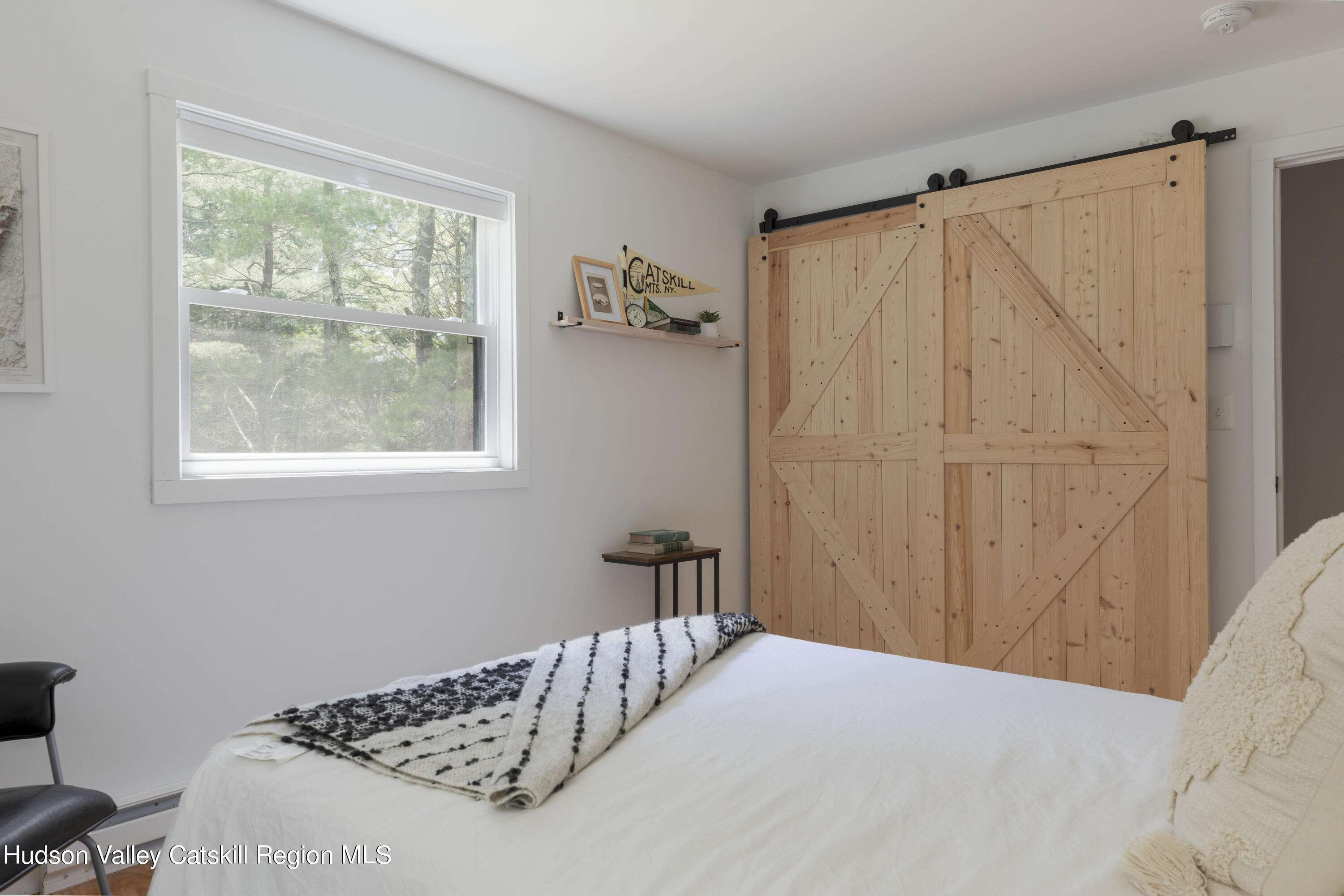 5646 Red Hill Road Claryville, NY 12725 - Photo 21 of 30 a bedroom with a bed and a window