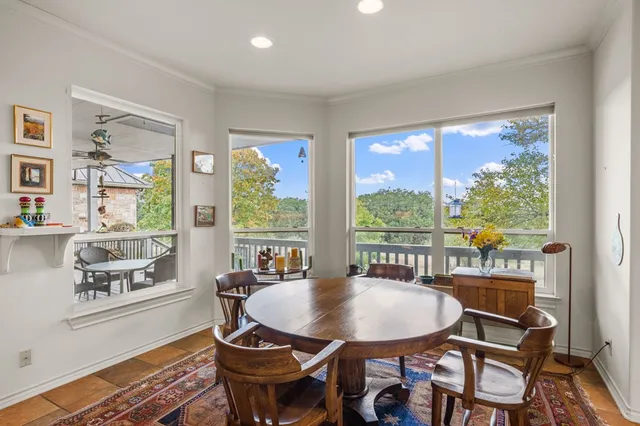 a dining room with furniture a rug and wooden floor