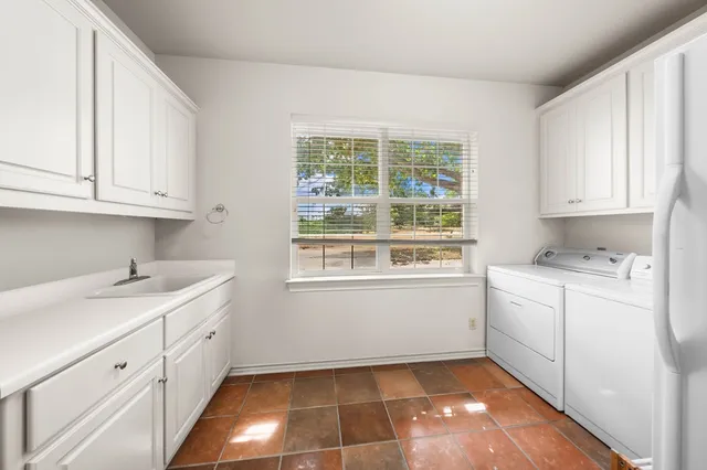 a kitchen with a white cabinets and white appliances