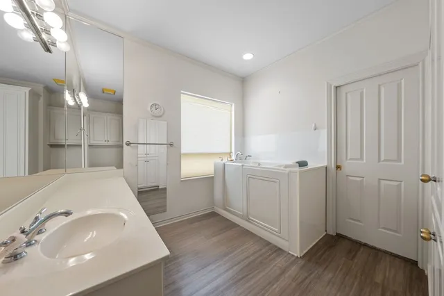 a bathroom with a sink a mirror and shower