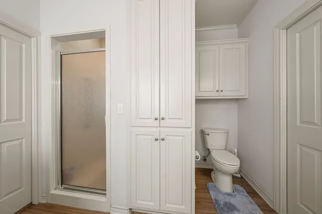 a white toilet sitting next to a bathroom sink