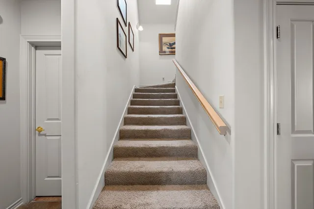 a view of staircase with white walls and windows