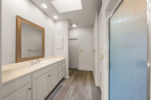 a spacious bathroom with a double vanity sink and a mirror