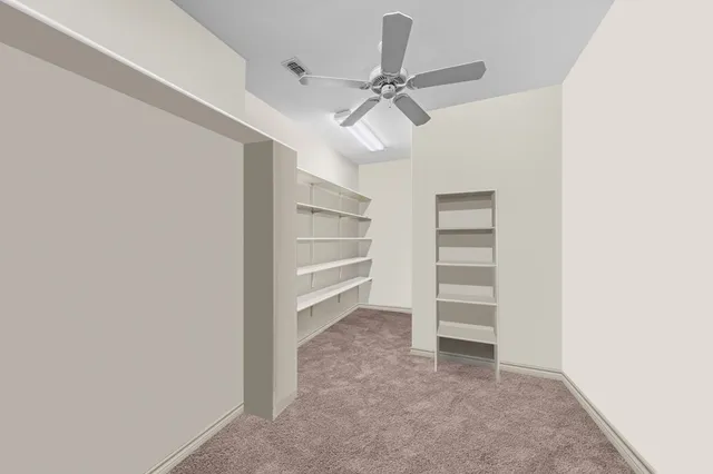 an empty room with a ceiling fan