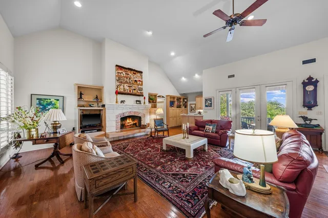 a living room with furniture fireplace and a large window