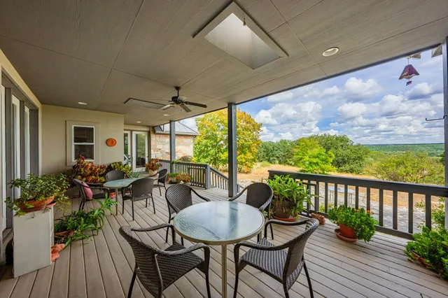 a view of a patio with table and chairs potted plants with wooden floor