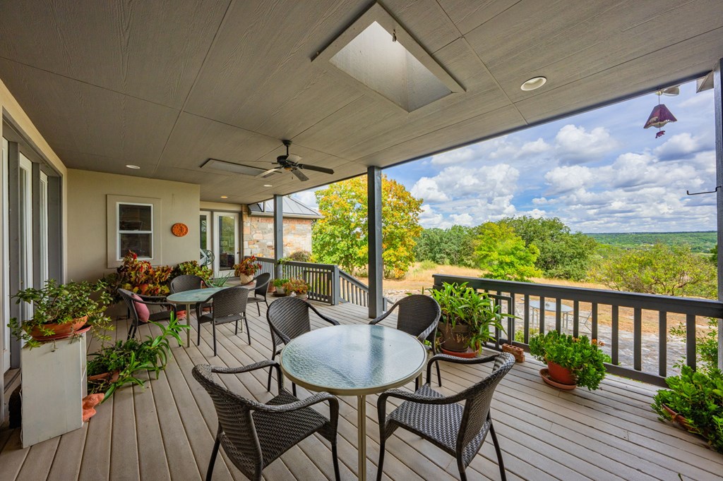 101 Crestline Kerrville, TX 78028 - Photo 31 of 47 a view of a patio with table and chairs potted plants with wooden floor