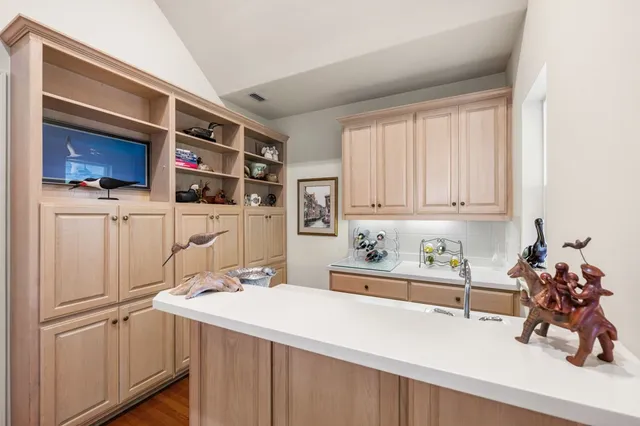 a room with furniture a flat screen tv and a refrigerator
