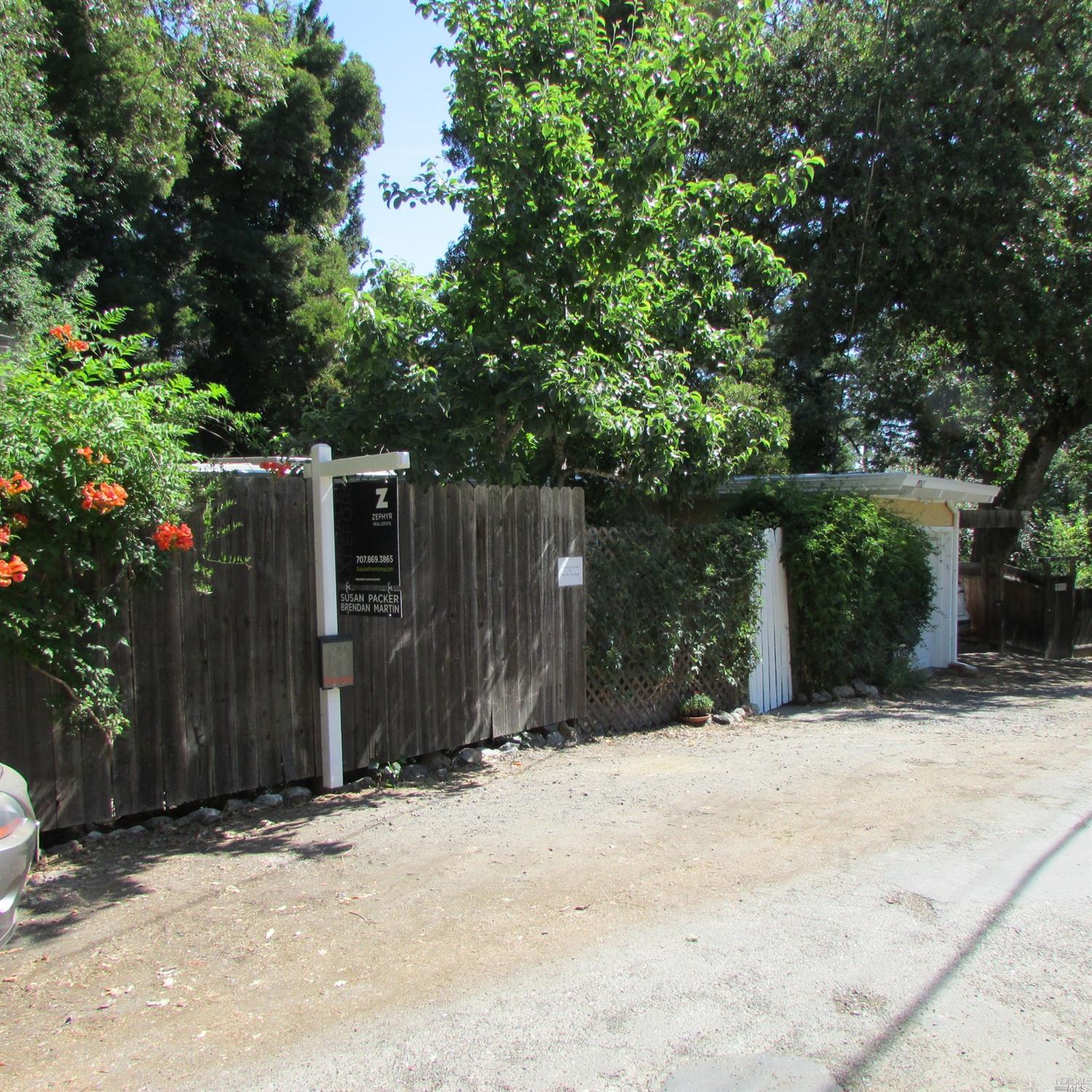 9365 Rio Vista Road Forestville, CA 95436 - Photo 1 of 1 a wooden fence under a large tree