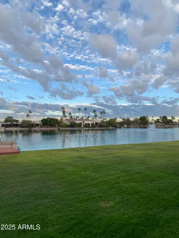 a view of a lake with houses in the back