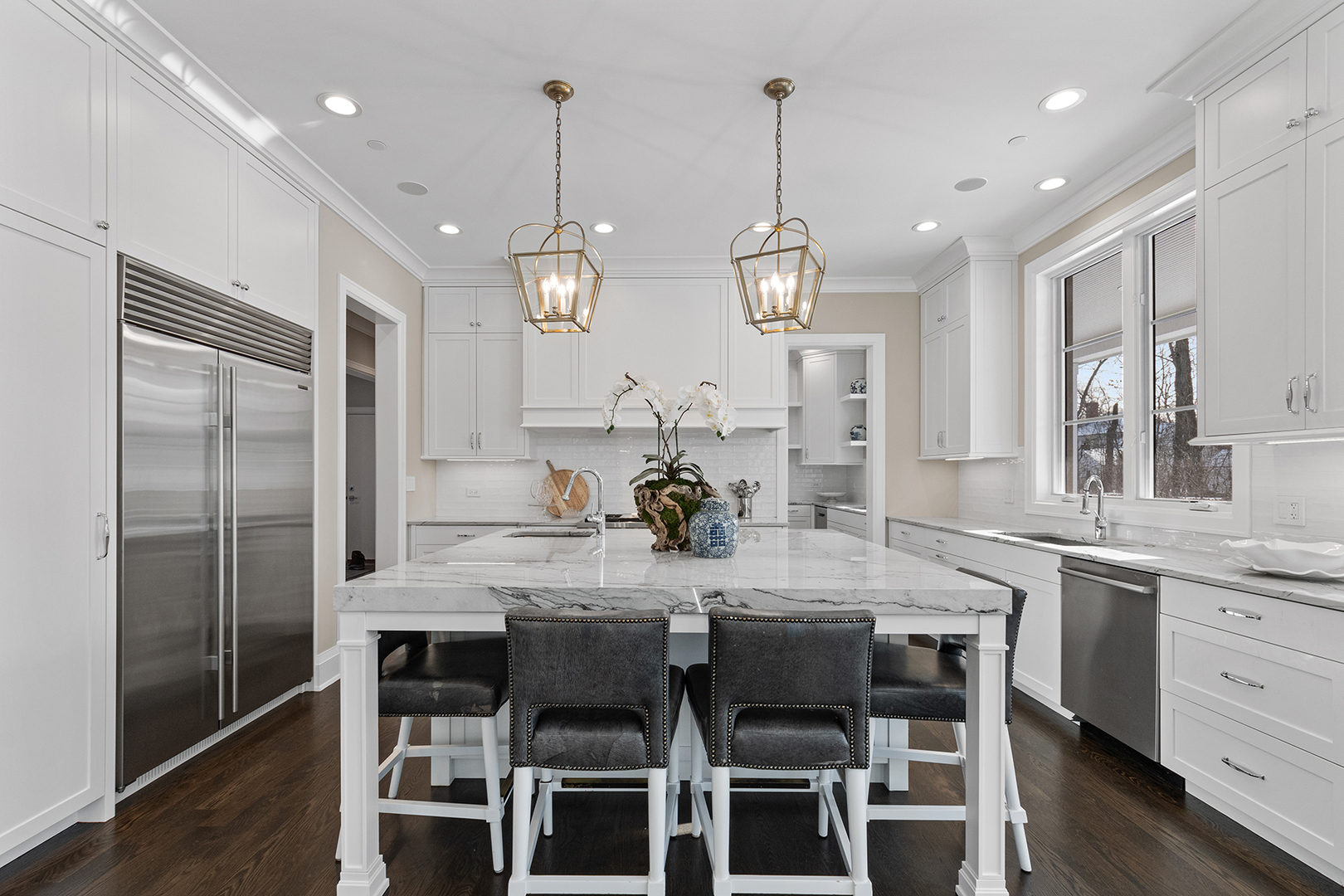 511 Lansdowne Lane Lake Bluff, IL 60044 - Photo 22 of 69 a kitchen with stainless steel appliances kitchen island granite countertop a dining table chairs and white cabinets