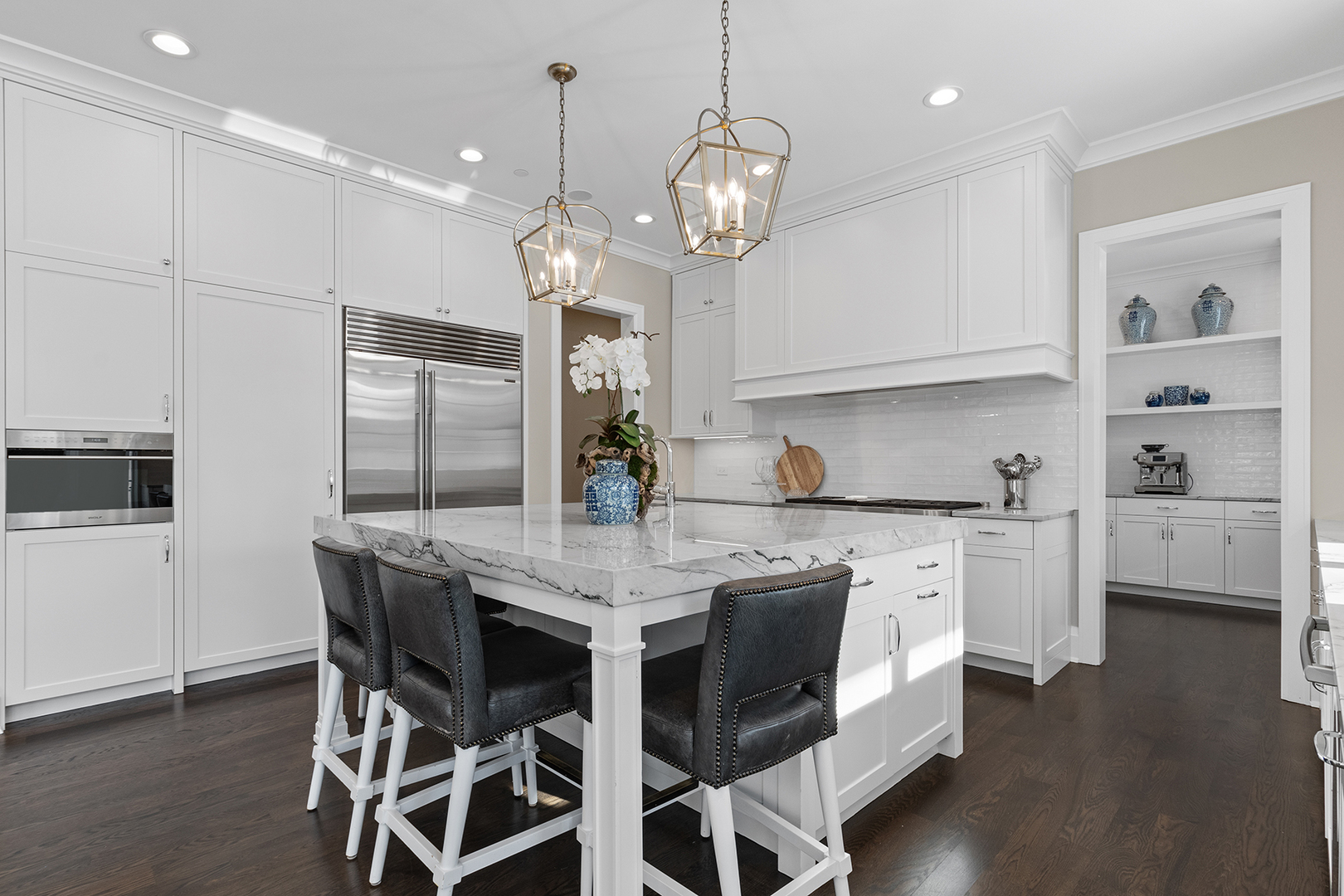 511 Lansdowne Lane Lake Bluff, IL 60044 - Photo 23 of 69 a kitchen with stainless steel appliances kitchen island granite countertop a table chairs in it and wooden floors