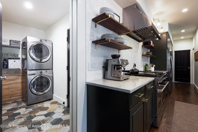 a kitchen with a stove a sink and cabinets