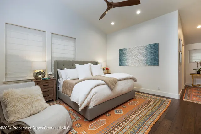 a bedroom with bed and a night stand