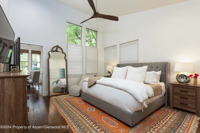 a bedroom with bed and a chandelier