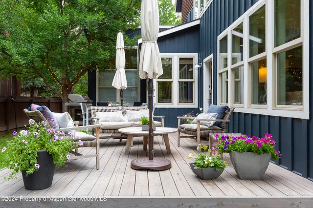 a view of a house with sitting area and potted plants