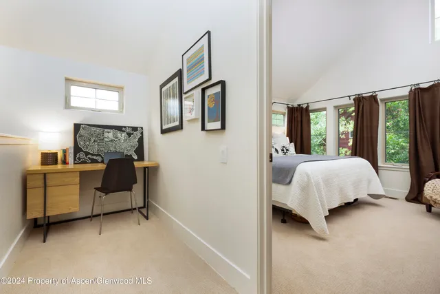 a bed room with a bed and a window