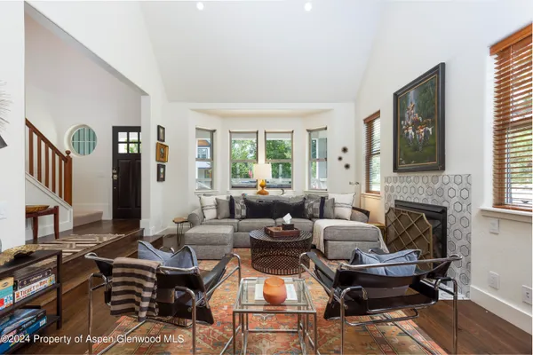 a living room with furniture fireplace and a flat screen tv