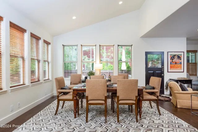a dining room with furniture and window