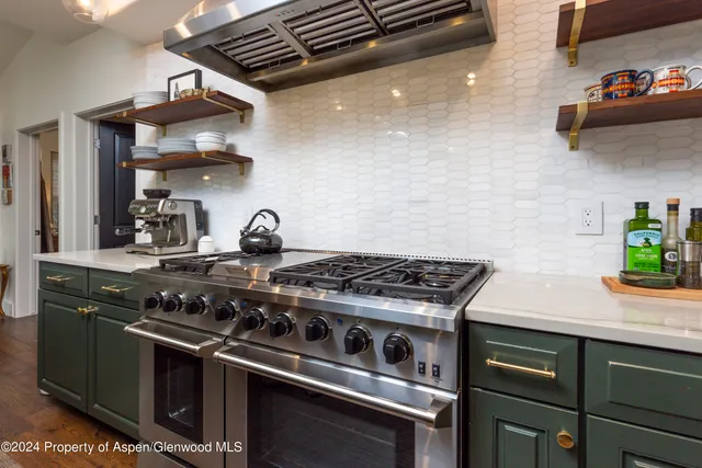 a stove top oven sitting inside of a kitchen