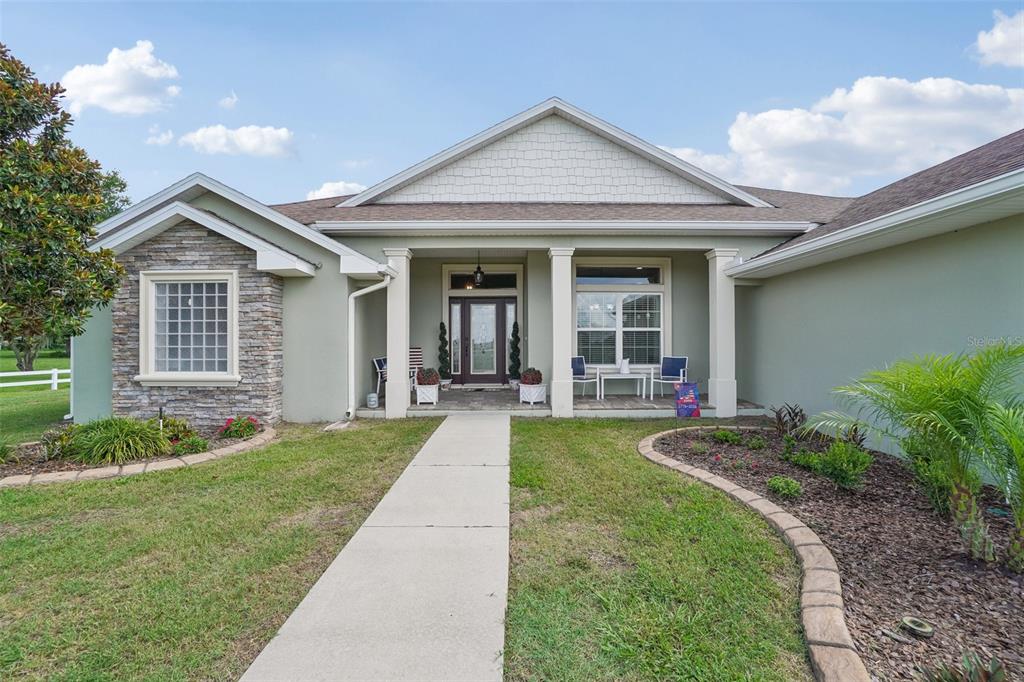 3934 Connersville Road Bartow, FL 33830 - Photo 13 of 81 a front view of a house with porch and garden