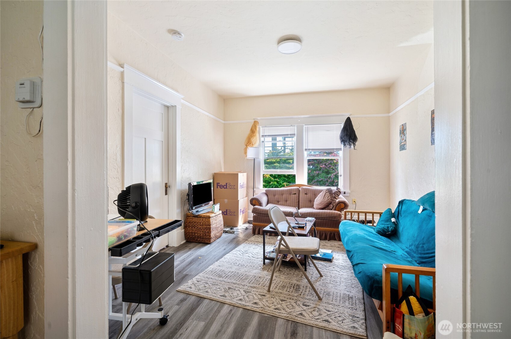 800 Harrison Street Seattle, WA 98109 - Photo 15 of 25 a living room with furniture a flat screen tv and a floor to ceiling window