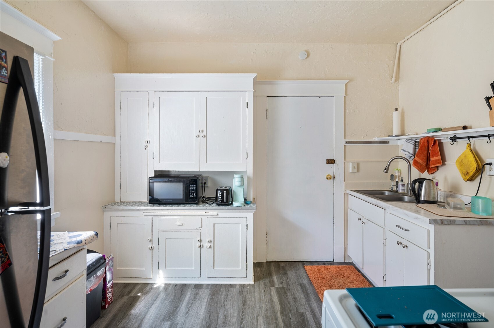800 Harrison Street Seattle, WA 98109 - Photo 16 of 25 a kitchen with stainless steel appliances a sink stove refrigerator and cabinets