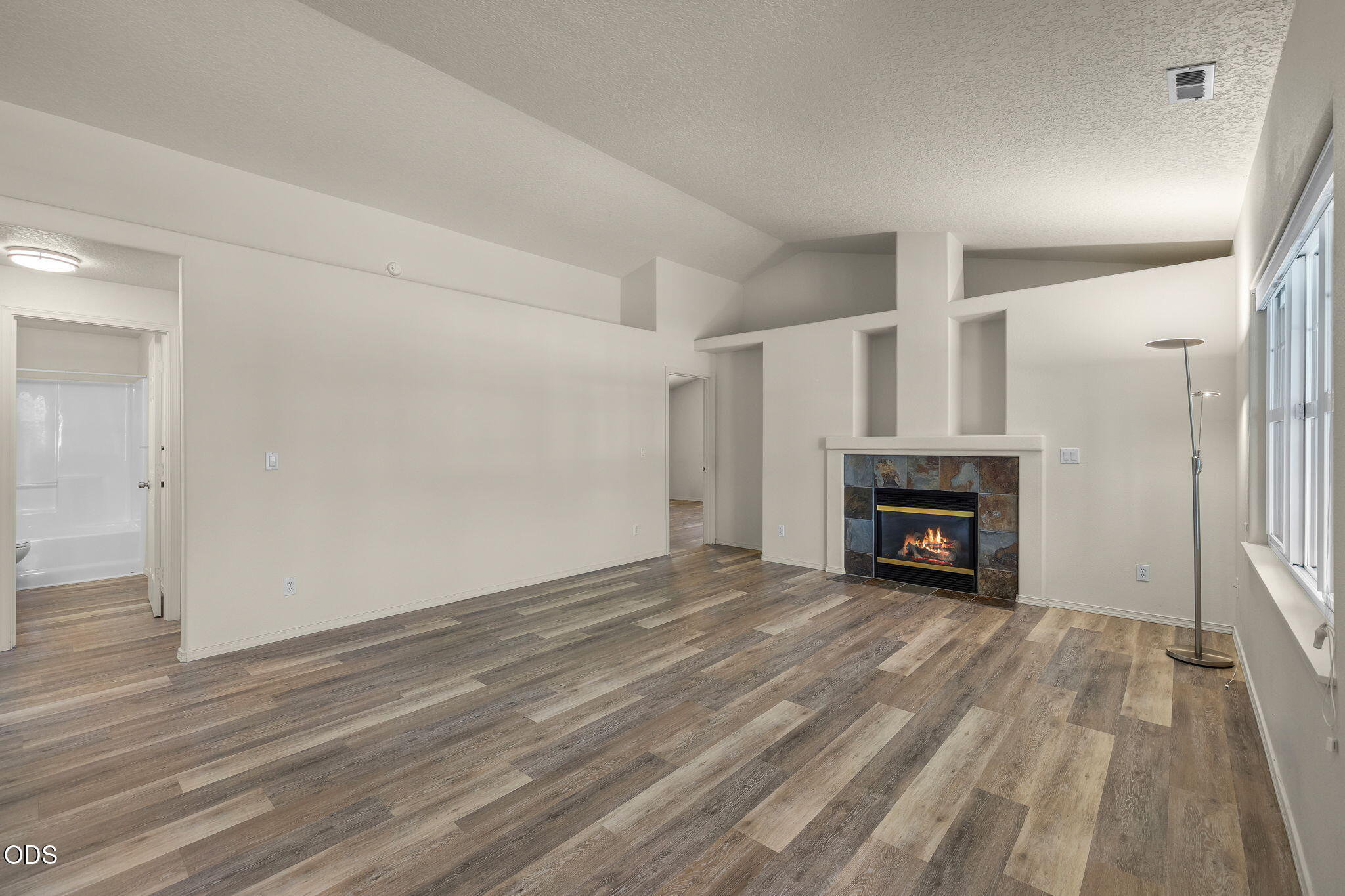 20535 Sunderland Way Bend, OR 97701 - Photo 16 of 41 a view of empty room with wooden floor and fireplace