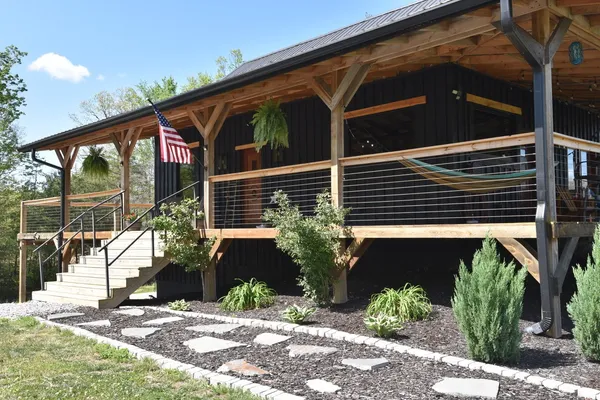 a view of a house with backyard porch and sitting area