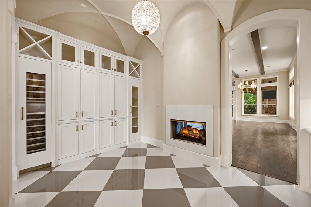 6900 Rockingham Court Colleyville, TX 76034 - Photo 11 of 40 Wine Room/Grotto Left View. Not shown is a Bar on right side. Built-in cabinetry with glass-front uppers and a dedicated wine refrigerator and ice maker.