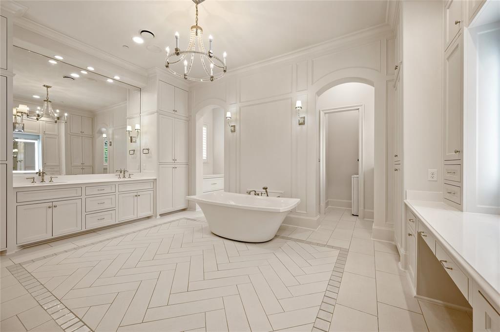 6900 Rockingham Court Colleyville, TX 76034 - Photo 16 of 40 Spacious Primary Bathroom featuring a freestanding soaking tub, dual vanity with extensive counter space, and integrated storage cabinetry. Also has a lighted mirror vanity, coffee bar with refrigerator, steam shower, and a 2nd dedicated laundry room