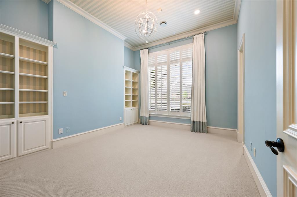 6900 Rockingham Court Colleyville, TX 76034 - Photo 18 of 40 Light blue room with a large window featuring white plantation shutters and floor-length drapes