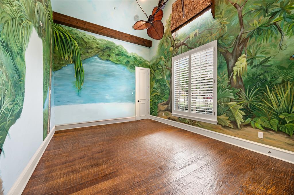 6900 Rockingham Court Colleyville, TX 76034 - Photo 19 of 40 Room featuring detailed wall murals, wood-finish flooring, a white window with plantation shutters, a solid white door, and exposed ceiling beams
