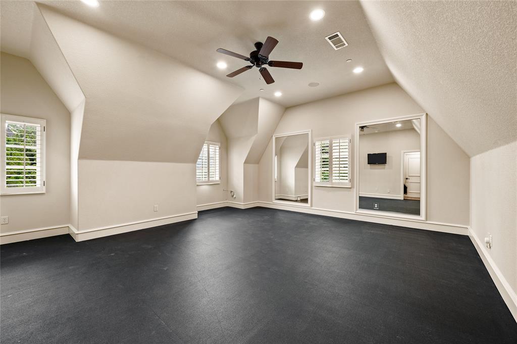6900 Rockingham Court Colleyville, TX 76034 - Photo 25 of 40 Home Gym/Yoga/Dance/Boxing Studio featuring dark rubber flooring, sloped ceilings, and recessed lighting