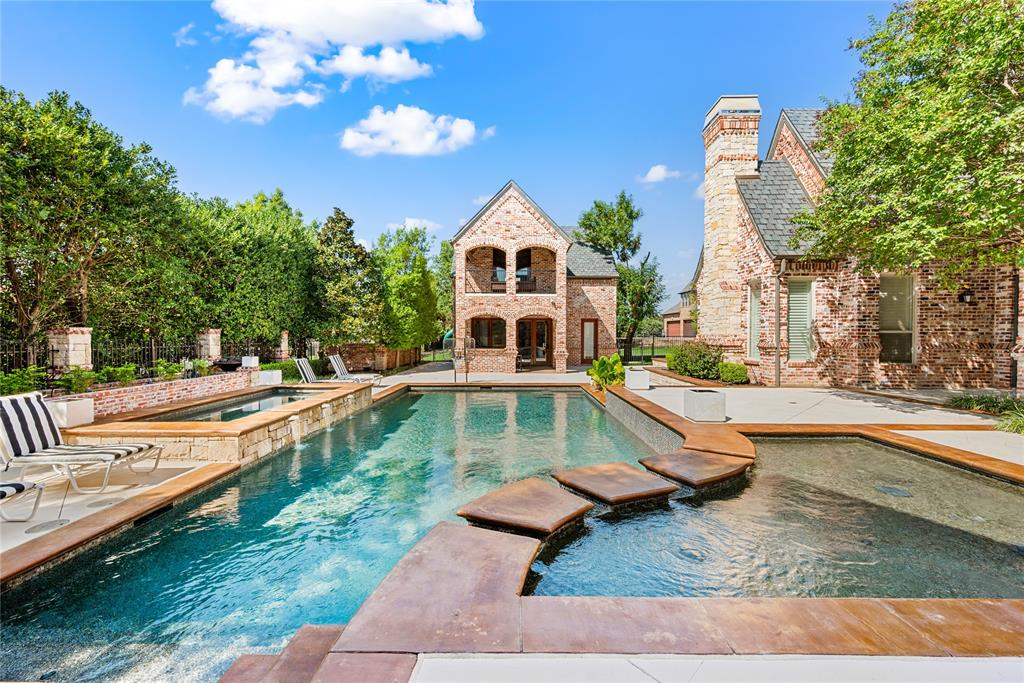 6900 Rockingham Court Colleyville, TX 76034 - Photo 28 of 40 Expansive outdoor oasis featuring a large swimming pool, integrated spa, and a separate wading area with stepping stones