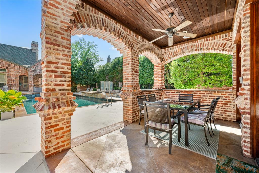6900 Rockingham Court Colleyville, TX 76034 - Photo 31 of 40 Covered patio off of Guest House ADU featuring brick arches and a wood-panel ceiling with a ceiling fan