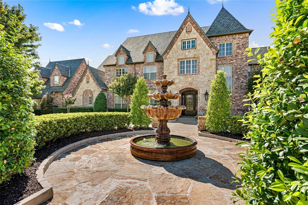 6900 Rockingham Court Colleyville, TX 76034 - Photo 5 of 40 Grand architectural facade featuring brick and stone cladding, multiple dormer windows, and a prominent turret