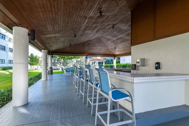 a view of a patio with table and chairs potted plants with wooden floor