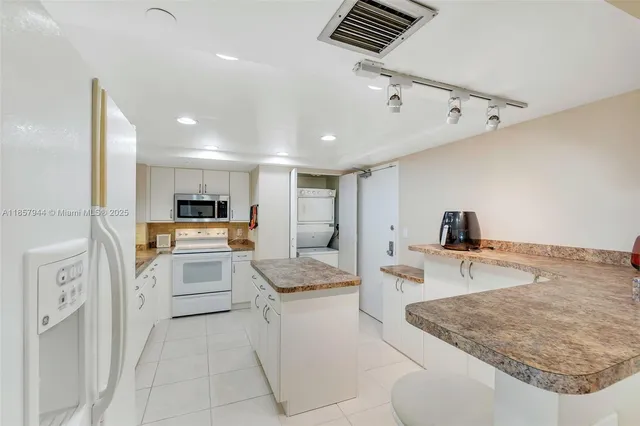 a kitchen with a refrigerator sink and stove