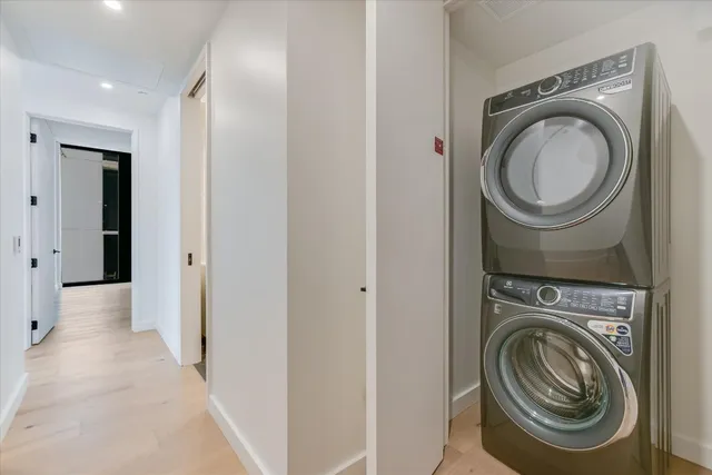 a view of a hallway with washer and dryer