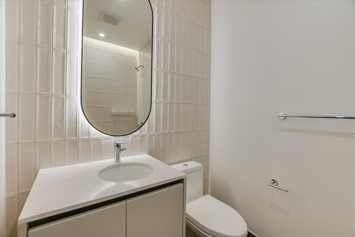 610 Davis Street, Unit 2505 Austin, TX 78701 - Photo 10 of 31 a bathroom with a sink a toilet and a mirror